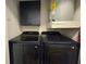 Laundry room with modern washer and dryer set, cabinet, and water heater at 2055 Lakeview Dr, Clearwater, FL 33763