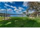 Enjoy the serene lake view from the lush green lawn, complete with picnic tables for relaxation and outdoor enjoyment at 2055 Lakeview Dr, Clearwater, FL 33763
