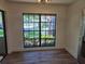 Bright living area with hardwood floors, large window overlooking the outdoor greenery at 2055 Lakeview Dr, Clearwater, FL 33763