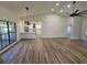 Open living area with modern lighting fixtures, wood floors, and a view of the kitchen and backyard at 2055 Lakeview Dr, Clearwater, FL 33763