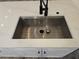 Close-up of modern kitchen sink with white countertop and black faucet at 2055 Lakeview Dr, Clearwater, FL 33763