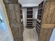 Walk-in closet featuring wooden sliding barn doors and custom shelving units at 2055 Lakeview Dr, Clearwater, FL 33763