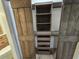 Walk-in closet boasting custom shelving and drawers, framed by rustic barn doors at 2055 Lakeview Dr, Clearwater, FL 33763