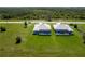 Aerial view of two modern homes, each featuring a private screened pool and well-maintained lawn at 223 Rotonda S Blvd, Rotonda West, FL 33947