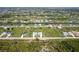 Expansive aerial view showing homes, interspersed with canals, set in a serene neighborhood at 223 Rotonda S Blvd, Rotonda West, FL 33947