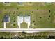 Aerial view of two homes, each with a pool, sitting parallel and connected via driveways to the main street at 223 Rotonda S Blvd, Rotonda West, FL 33947