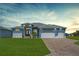 Charming single-story home with a three-car garage, lush lawn, and inviting curb appeal at 223 Rotonda S Blvd, Rotonda West, FL 33947
