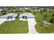 Beautifully landscaped home featuring a well-manicured lawn and a paved driveway at 223 Rotonda S Blvd, Rotonda West, FL 33947