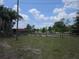 Exterior shot of the property featuring a large yard, multiple trees, and a barn at 23046 Brandy Rd, Land O Lakes, FL 34639