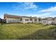 Spacious backyard with lush green grass, white fence, patio and pergola at 4043 Topsail Trl, New Port Richey, FL 34652