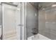 Bathroom showing walk-in shower with tile walls, door and bathtub at 4043 Topsail Trl, New Port Richey, FL 34652