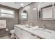 Contemporary bathroom with a double vanity, decorative mirrors and tile accents at 4043 Topsail Trl, New Port Richey, FL 34652
