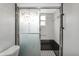 Bathroom featuring a shower with decorative sliding glass doors and black and white tile at 4043 Topsail Trl, New Port Richey, FL 34652