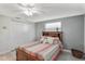 Bedroom with closet, a window with blinds and wood-look flooring at 4043 Topsail Trl, New Port Richey, FL 34652
