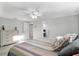 Bedroom with a ceiling fan, wood-look floors, white walls and white trim at 4043 Topsail Trl, New Port Richey, FL 34652