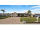 Single-story home with brick driveway and lush, green lawn, offering a welcoming exterior at 4043 Topsail Trl, New Port Richey, FL 34652