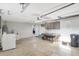 Organized garage space including laundry area and storage cabinets, offering practical functionality at 4043 Topsail Trl, New Port Richey, FL 34652