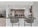 A modern kitchen with a stainless steel refrigerator and a granite breakfast bar with barstool seating at 4043 Topsail Trl, New Port Richey, FL 34652
