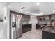 This modern kitchen features stainless steel appliances, dark wood cabinets, recessed lighting, and light wood flooring at 4043 Topsail Trl, New Port Richey, FL 34652