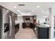 Modern kitchen with stainless steel appliances, granite countertops, and light wood flooring at 4043 Topsail Trl, New Port Richey, FL 34652