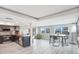 Bright living room area with a modern kitchen and an adjacent dining space with views of the outdoors at 4043 Topsail Trl, New Port Richey, FL 34652
