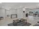 This open floor plan includes a stylish living room with light wood floors and neutral walls with recessed lights at 4043 Topsail Trl, New Port Richey, FL 34652