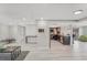 Open-concept living room featuring a kitchen with modern appliances and light wood flooring throughout at 4043 Topsail Trl, New Port Richey, FL 34652