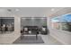 Modern living room with light grey walls, wood floors, neutral furniture, and bright natural light at 4043 Topsail Trl, New Port Richey, FL 34652