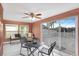 Cozy sunroom with a ceiling fan, a table set, and sliding glass doors to the backyard at 4043 Topsail Trl, New Port Richey, FL 34652