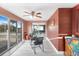 Bright sunroom with table set, ceiling fan and sliding glass doors leading to the backyard at 4043 Topsail Trl, New Port Richey, FL 34652