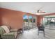 Cozy sunroom with a ceiling fan, tiled floors, and sliding glass doors to the backyard at 4043 Topsail Trl, New Port Richey, FL 34652