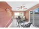 Sunroom featuring a table set, ceiling fan and windows for natural light and view to the backyard at 4043 Topsail Trl, New Port Richey, FL 34652