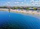 Breathtaking water view showcasing the beach, clear water, and a line of charming beachfront homes at 4043 Topsail Trl, New Port Richey, FL 34652