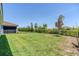 Spacious backyard with lush green grass and black fence at 507 Daylily Blvd, Nokomis, FL 34275