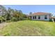 Spacious backyard with a covered patio, fence and view of wooded area at 507 Daylily Blvd, Nokomis, FL 34275