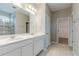 Bathroom featuring double sink vanity, walk-in shower, tile flooring, and neutral paint at 507 Daylily Blvd, Nokomis, FL 34275