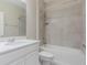 Bright bathroom featuring a shower over tub combination, and a white vanity with solid surface countertop at 507 Daylily Blvd, Nokomis, FL 34275