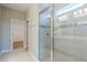 Bright bathroom showcasing walk-in shower with glass door, tile floor, and neutral paint at 507 Daylily Blvd, Nokomis, FL 34275