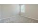 Bedroom with neutral walls, carpeted floor, a window and white trim at 507 Daylily Blvd, Nokomis, FL 34275