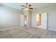 Bedroom with carpet, a ceiling fan, neutral paint, and two closets at 507 Daylily Blvd, Nokomis, FL 34275