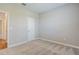 Bedroom with neutral carpet, neutral painted walls, and a white door at 507 Daylily Blvd, Nokomis, FL 34275