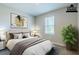 A virtually staged bedroom featuring a large bed, neutral walls, and natural light at 507 Daylily Blvd, Nokomis, FL 34275