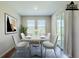 Staged dining area with marble table, four chairs and natural lighting at 507 Daylily Blvd, Nokomis, FL 34275
