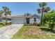 Charming single-story home with a red tile roof and tropical landscaping at 507 Daylily Blvd, Nokomis, FL 34275