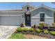 Beautiful front of home with a two-car garage and stone-paved walkway at 507 Daylily Blvd, Nokomis, FL 34275