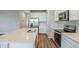 Modern kitchen with stainless steel appliances and a large quartz island at 507 Daylily Blvd, Nokomis, FL 34275