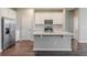 Bright kitchen with stainless steel appliances and a large center island at 507 Daylily Blvd, Nokomis, FL 34275