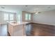 Open concept living room features a kitchen island, hardwood floors and natural light at 507 Daylily Blvd, Nokomis, FL 34275