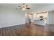 Spacious living room with wood floors connected to kitchen with stainless appliances at 507 Daylily Blvd, Nokomis, FL 34275
