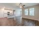Bright living area with a ceiling fan and access to the kitchen and dining areas at 507 Daylily Blvd, Nokomis, FL 34275